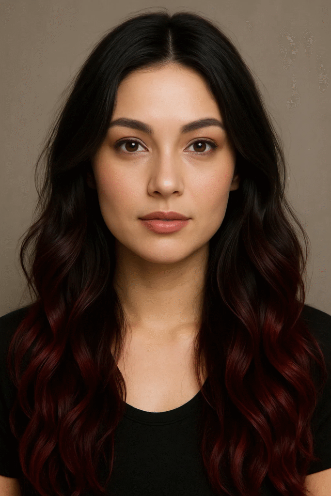 Deep cherry cola hair with black roots on long wavy hair