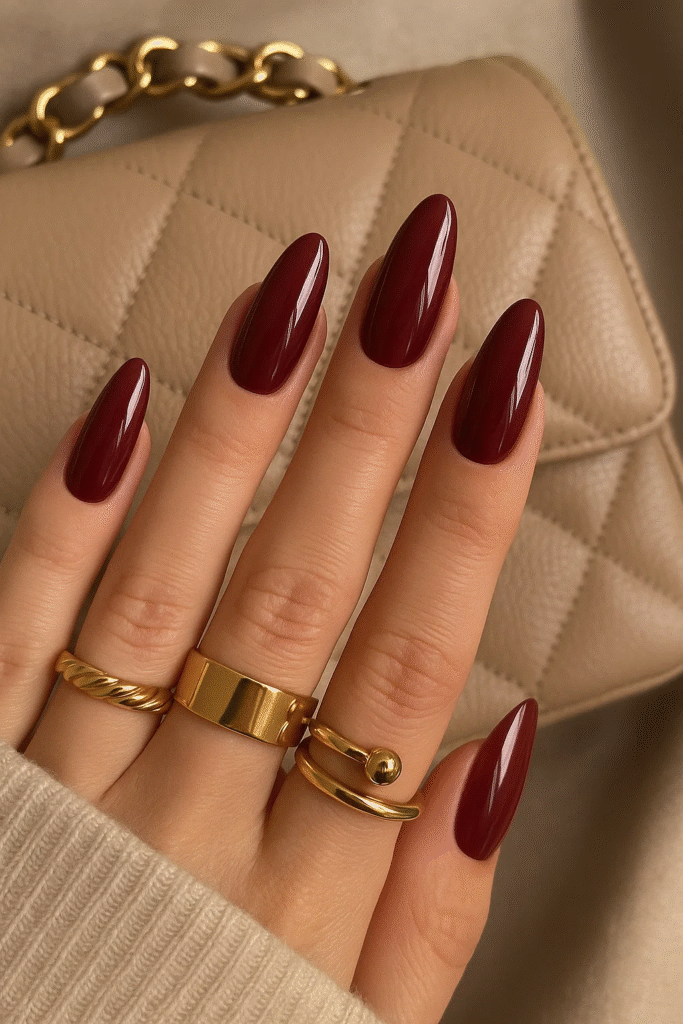 burgundy nails 2025 glossy trend with gold accessories