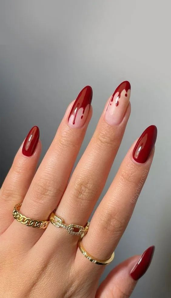 Blood drip Halloween nails with deep red tips and nude base, creating a dramatic and spooky effect.