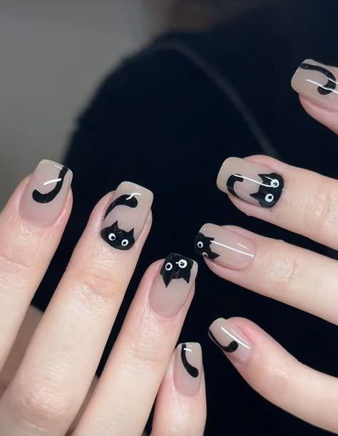 Black French tip Halloween nails with cute black cat face designs and sparkling stars, ideal for a spooky yet elegant look.