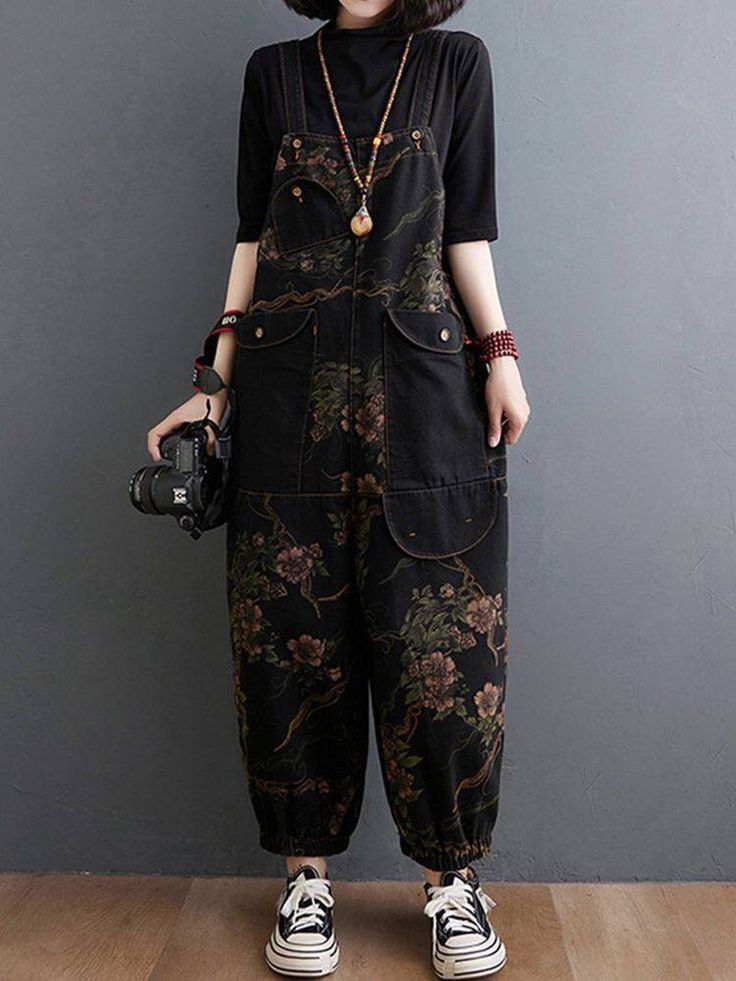 black dungarees with floral pattern and big pockets, styled with black tee and striped sneakers