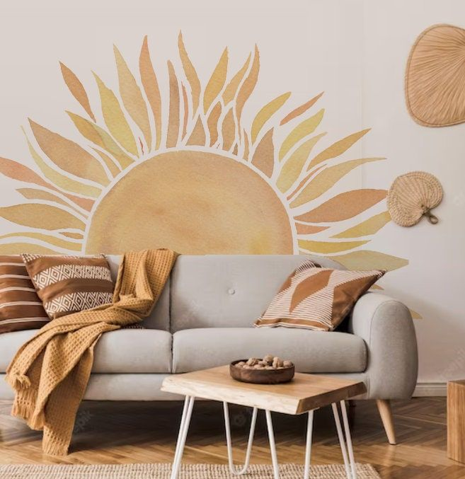 boho living room with watercolor sun wall mural nature behind neutral sofa and woven decor