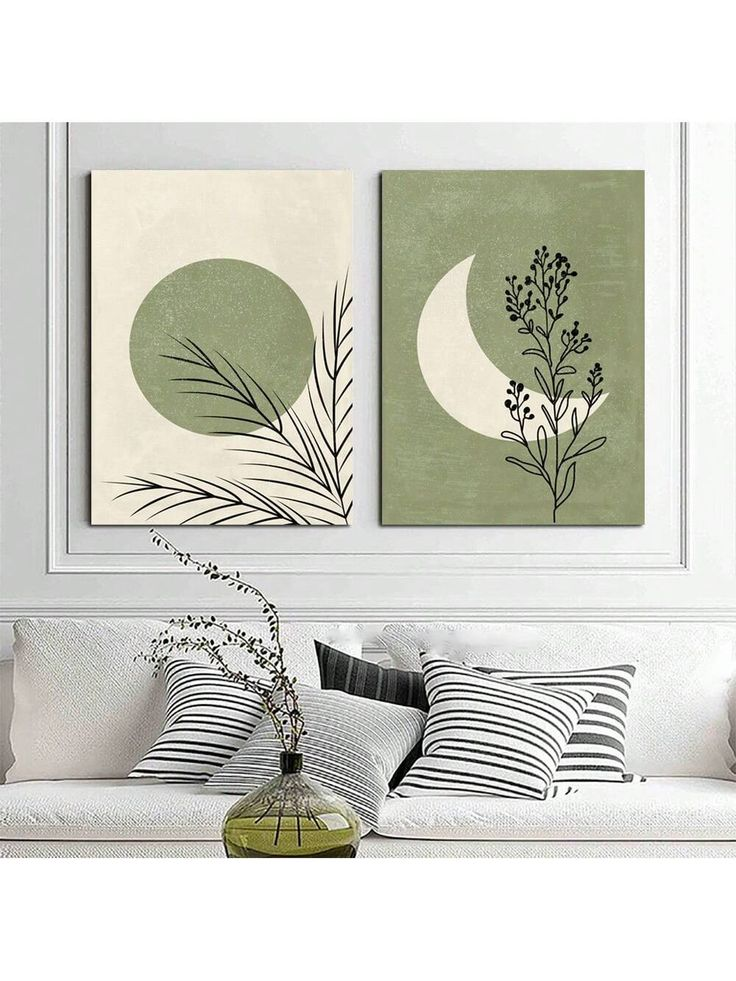 minimal moon and sun botanical art prints above neutral sofa with striped pillows