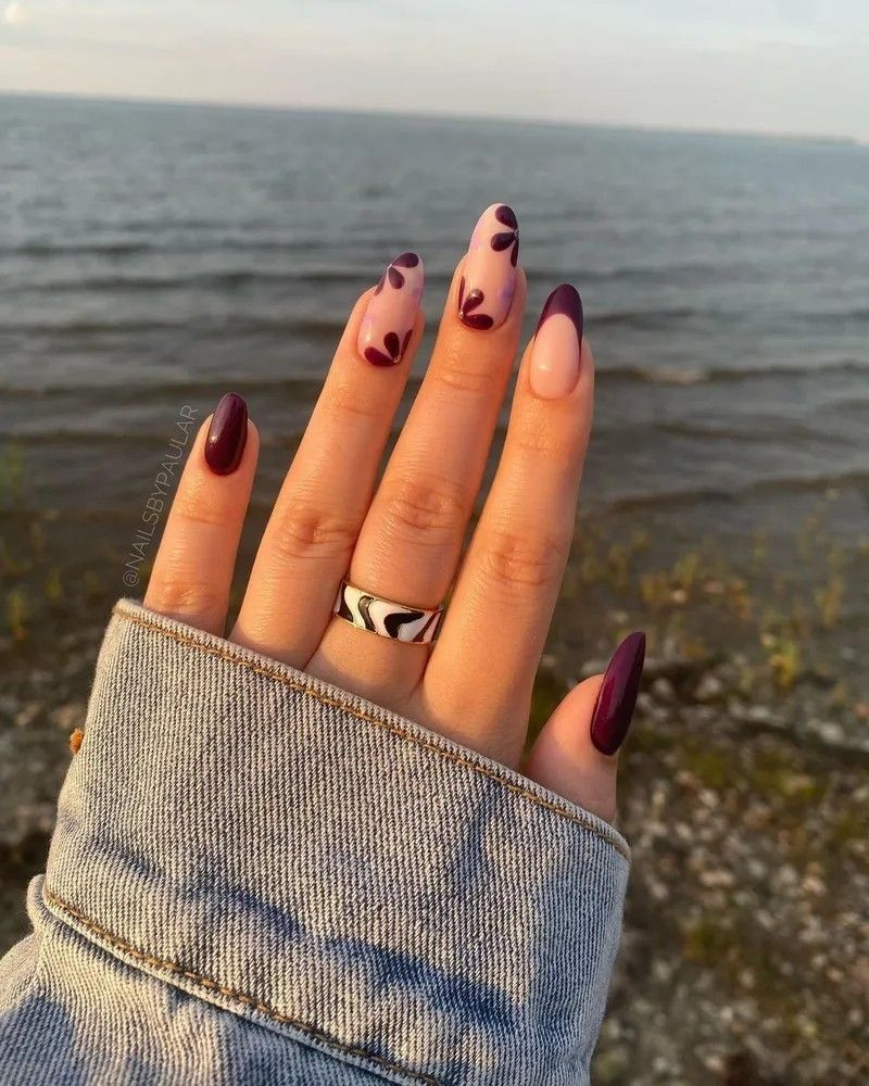 plum fall nails with petal tip design on sheer nude, almond nails by the sea
