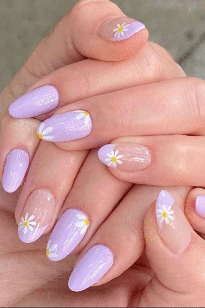 pastel lilac daisy nails with nude accents and single white flowers, glossy almond oval