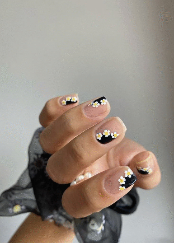 short almond nude matte nails with tiny black star accents, minimalist nail art