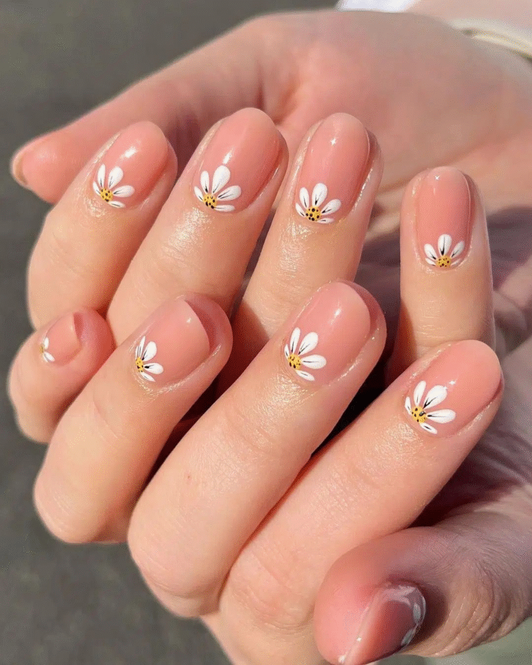 short peach jelly nails with small white daisies at cuticle, glossy oval