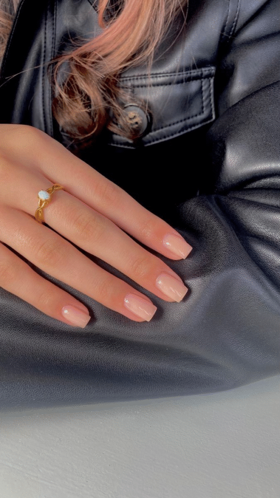 Classic squoval old money nails painted in creamy nude with glass shine.”