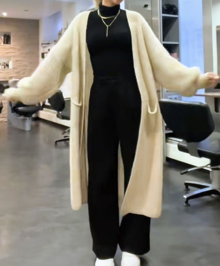 winter comfort dresses layering — black turtleneck and trousers with ankle-length oatmeal cardigan and white sneakers