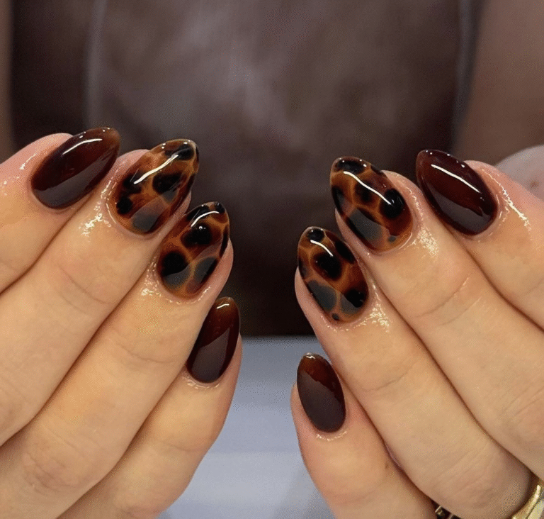 Medium almond tortoiseshell nails in caramel, amber and espresso jelly with glossy finish; some nails full tortie, others deep espresso solid.