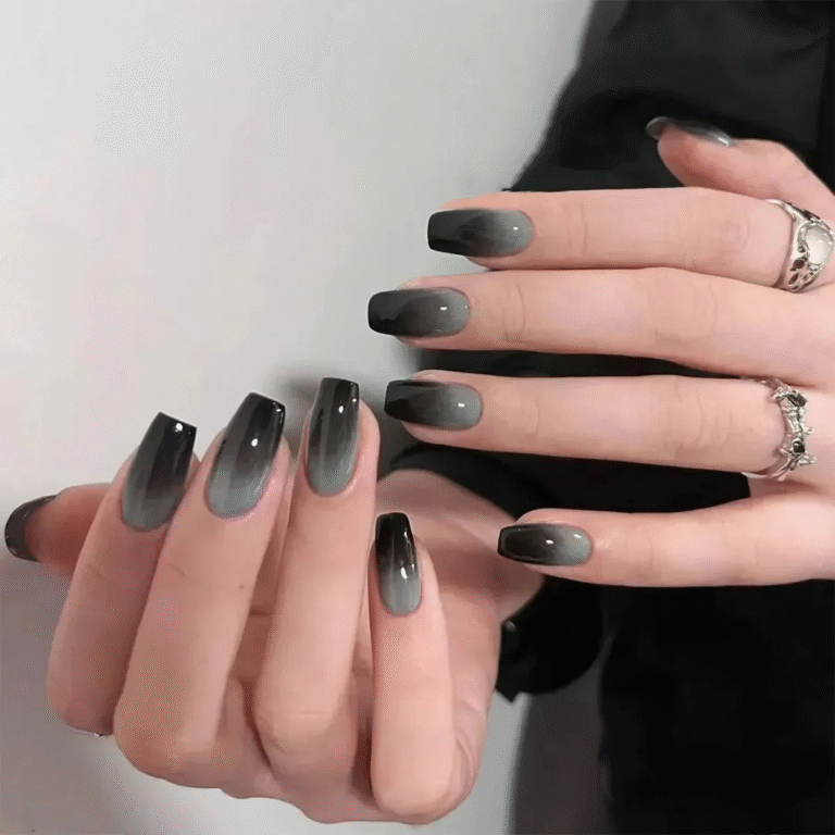 Medium coffin nails featuring a smoky charcoal-to-black ombré, sleek high-shine finish.