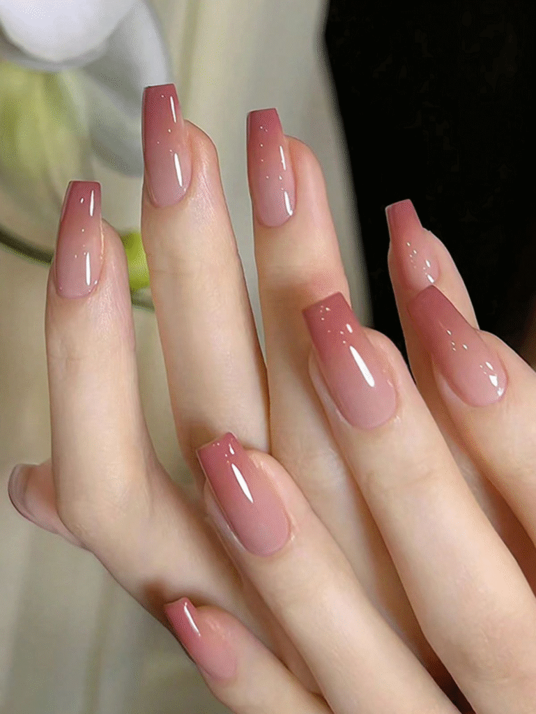 Neutral nude-to-taupe ombré on long soft-square nails with a high-gloss top coat.