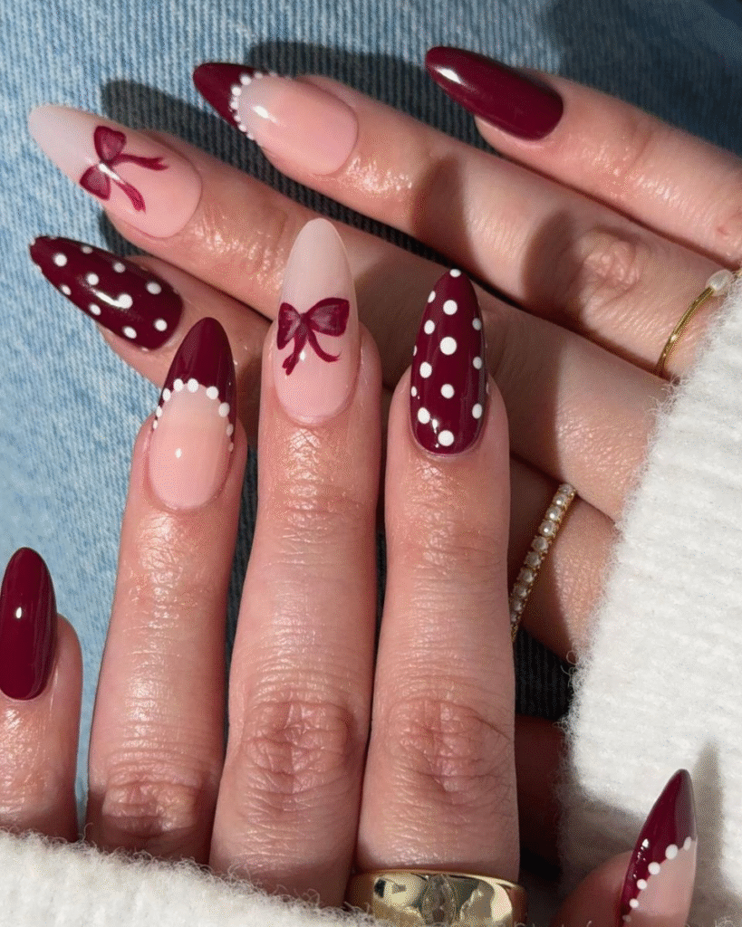 Mixed cherry coded manicure with bows, polka dots, and micro-French tips on almond nails.