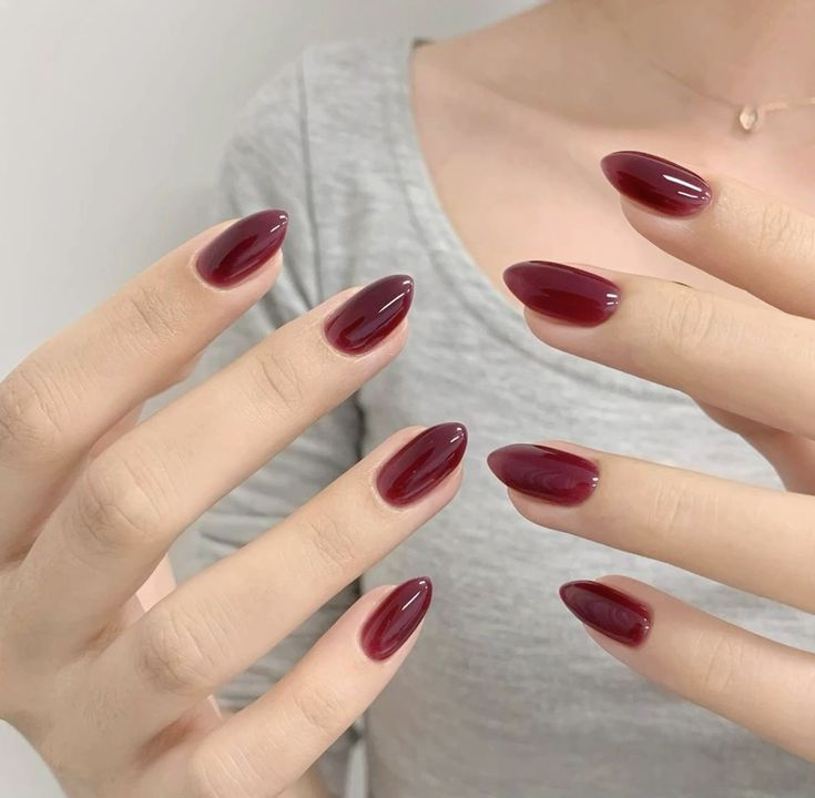 Simple cherry coded jelly manicure on short oval nails—clean, glass-like shine.