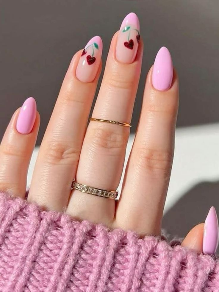 Medium almond aesthetic nails with ruby curved French tips, tiny white bows, cherry art, and scattered crystals on a nude base.