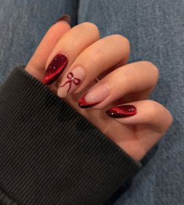 French cat-eye tips in red with bow accent.