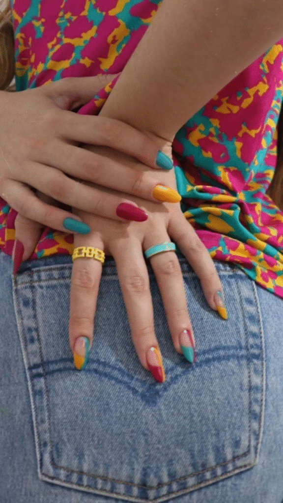 Color-blocked Skittle / Mismatched palettes French tips with denim and bright tee.